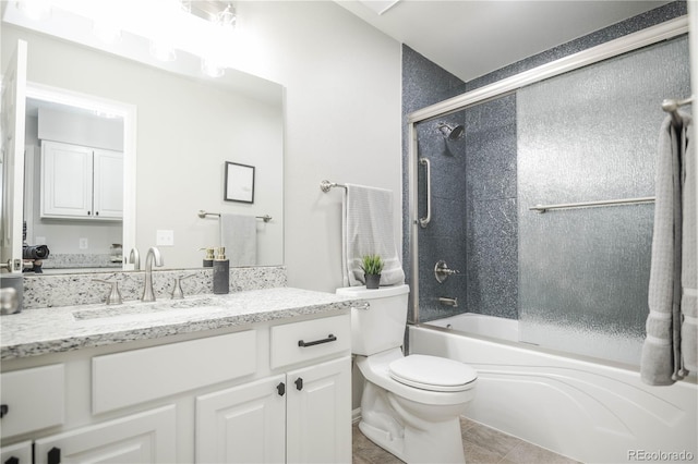 full bathroom with vanity, toilet, tile patterned flooring, and combined bath / shower with glass door