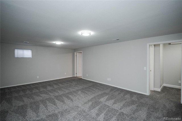 basement featuring dark carpet