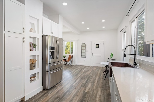 kitchen with stainless steel fridge with ice dispenser, dark hardwood / wood-style floors, white cabinetry, and plenty of natural light