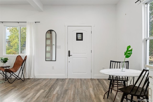 entrance foyer with wood-type flooring and beamed ceiling