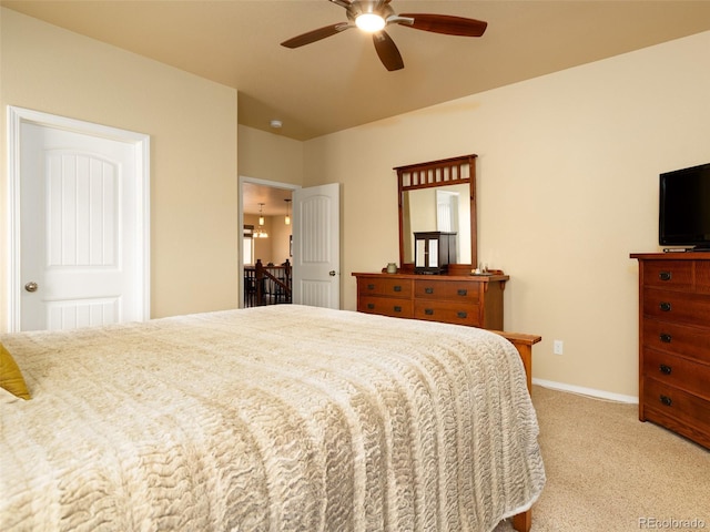 bedroom with baseboards, light carpet, and ceiling fan