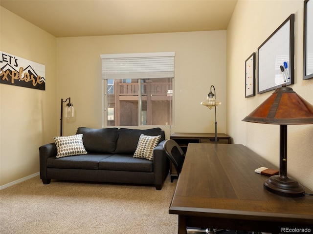 carpeted living area featuring baseboards