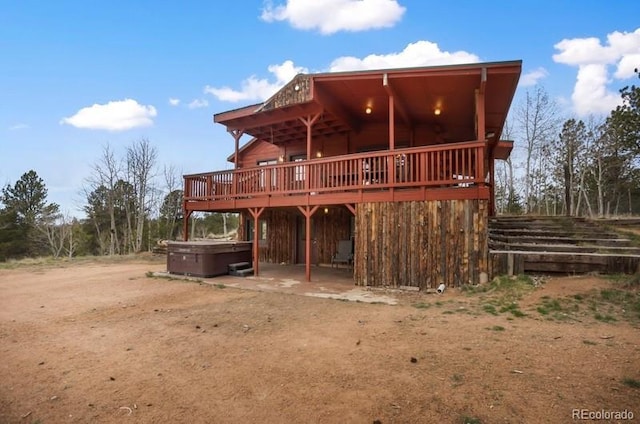79 Beaver Creek Cir, Florissant, CO 80816 - rear view of property featuring a hot tub, a deck, and a patio area