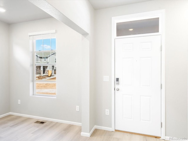 entrance foyer featuring visible vents, light wood-style flooring, and baseboards