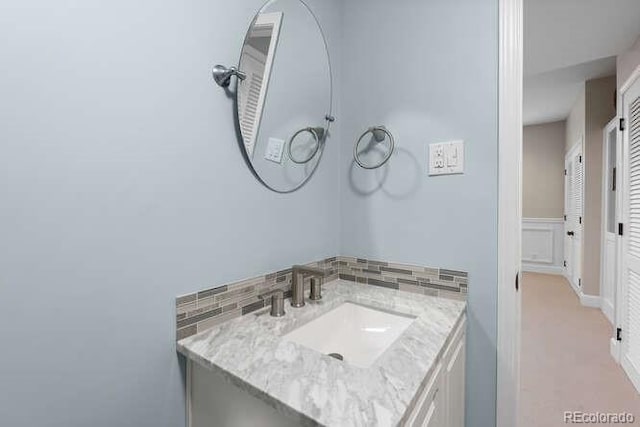 bathroom with backsplash and vanity