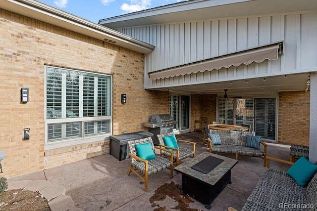 view of patio with area for grilling and an outdoor living space