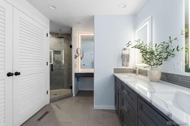 bathroom with tile patterned flooring, vanity, and an enclosed shower