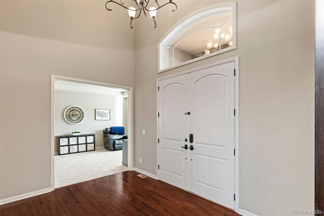 entrance foyer featuring wood-type flooring and a chandelier