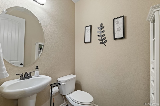 bathroom with toilet and sink