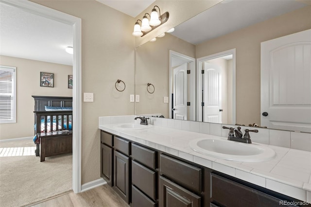 bathroom with vanity and hardwood / wood-style floors