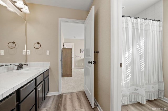 bathroom with wood-type flooring, a wealth of natural light, and vanity