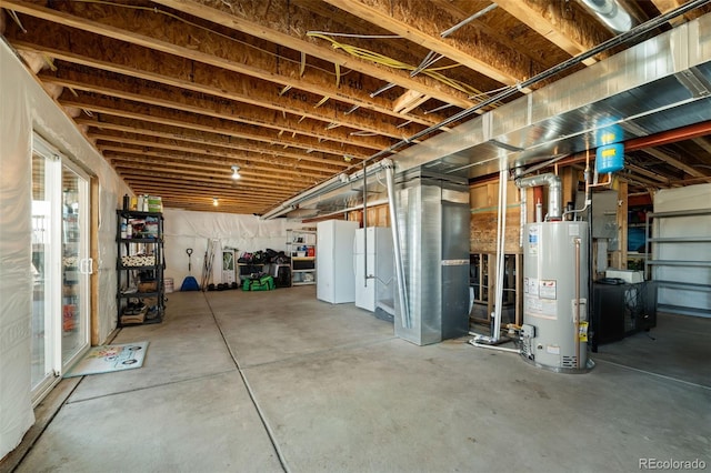 basement featuring water heater and white refrigerator