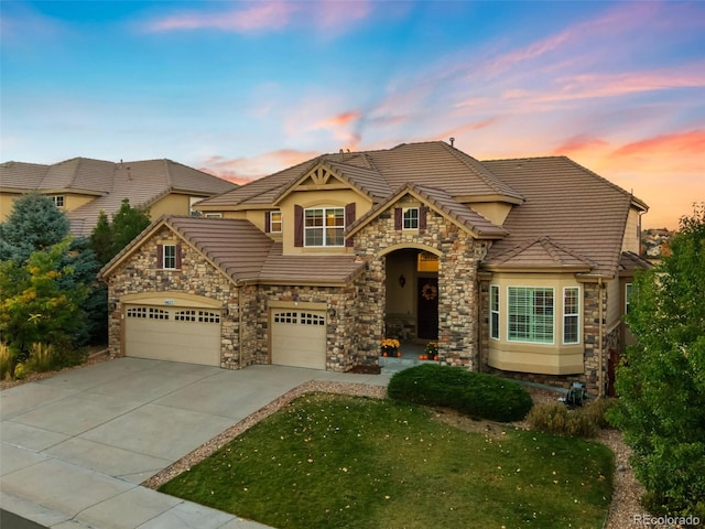 view of front of home featuring a garage and a lawn