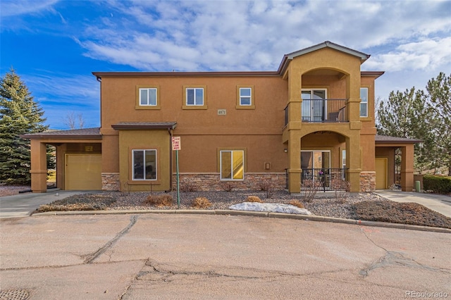 view of front of home with a garage and a balcony