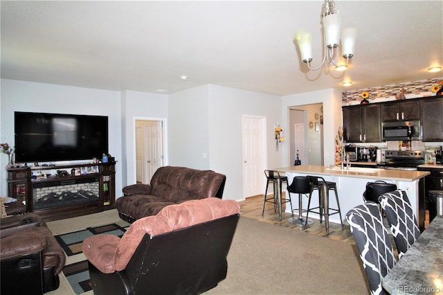 713 Indigo St, Brighton, CO 80603 - living room featuring light wood-style flooring and a chandelier