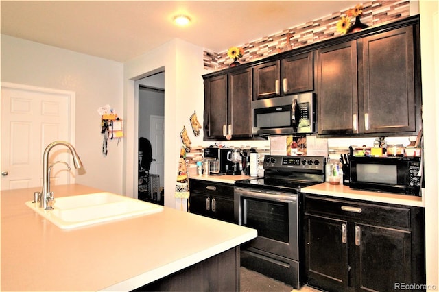 713 Indigo St, Brighton, CO 80603 - kitchen with appliances with stainless steel finishes, light countertops, and dark brown cabinets