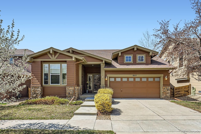10117 Waco St, Commerce City, CO 80022 - craftsman-style home featuring stone siding, driveway, roof with shingles, and an attached garage