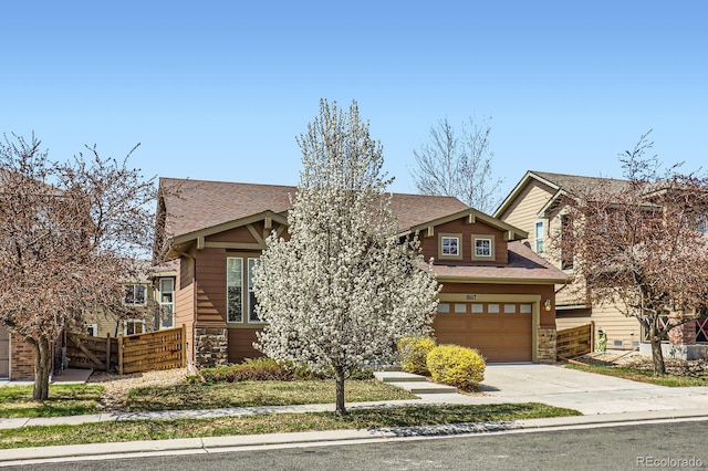 10117 Waco St, Commerce City, CO 80022 - view of front facade with stone siding, driveway, a garage, and roof with shingles