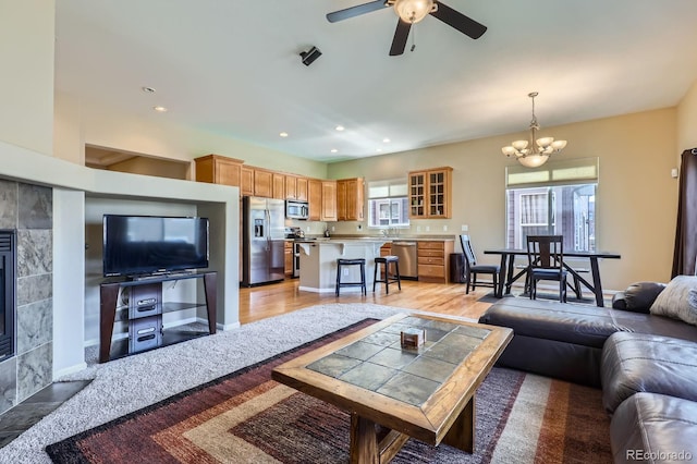 10117 Waco St, Commerce City, CO 80022 - living area with ceiling fan, a fireplace, a chandelier, light wood-style floors, and recessed lighting