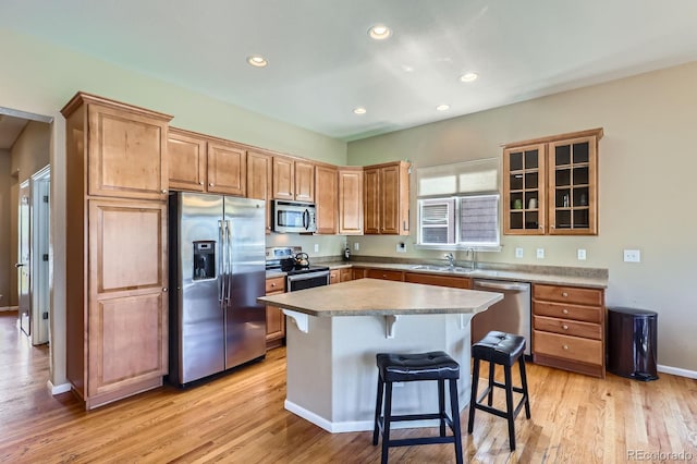 10117 Waco St, Commerce City, CO 80022 - kitchen featuring stainless steel appliances, a breakfast bar, light wood-style flooring, recessed lighting, and a kitchen island