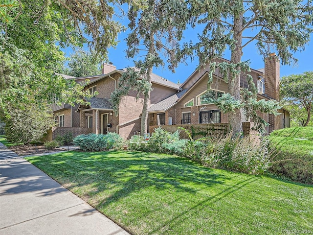 3540 E 5th Ave, Denver, CO 80206 - view of front of property with a chimney, brick siding, and a front lawn