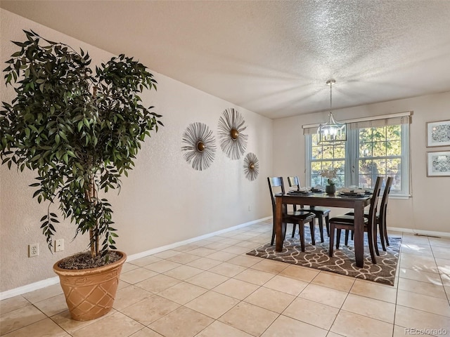 3540 E 5th Ave, Denver, CO 80206 - dining room with light tile patterned floors, a textured ceiling, and baseboards