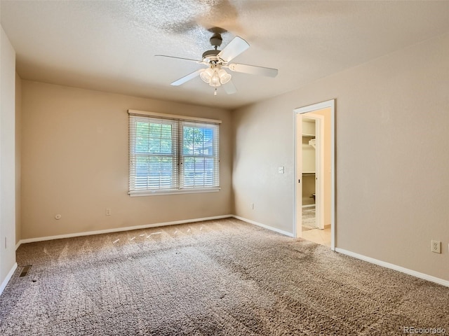 3540 E 5th Ave, Denver, CO 80206 - unfurnished bedroom featuring light carpet, baseboards, and ceiling fan