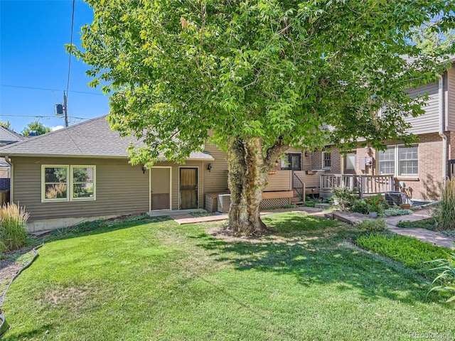 3540 E 5th Ave, Denver, CO 80206 - view of front of property featuring a wooden deck, a front yard, a shingled roof, cooling unit, and brick siding