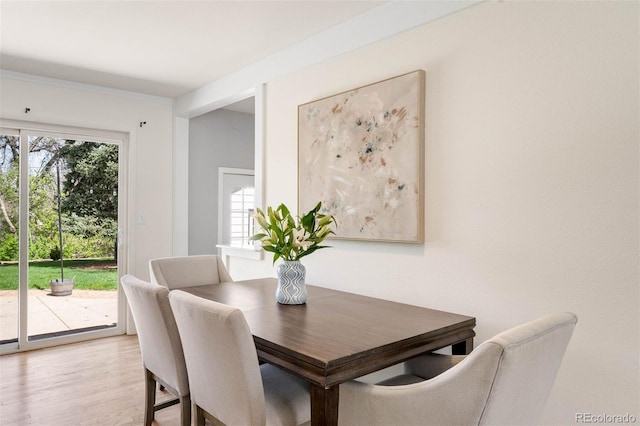 dining space featuring light wood finished floors
