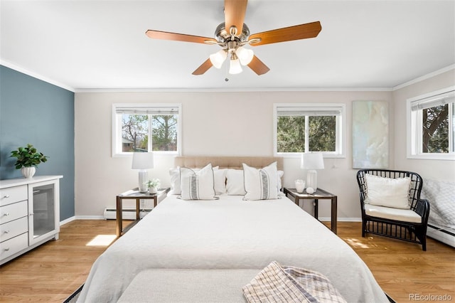 bedroom featuring crown molding, multiple windows, and a baseboard heating unit
