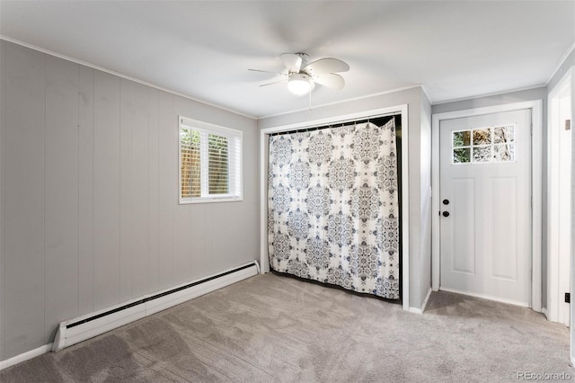interior space featuring crown molding, a baseboard radiator, ceiling fan, and carpet flooring