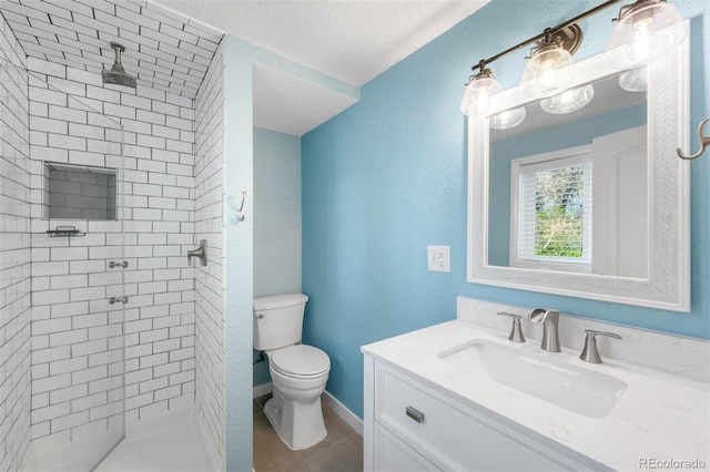 bathroom featuring vanity, toilet, tile patterned floors, a textured ceiling, and a shower stall