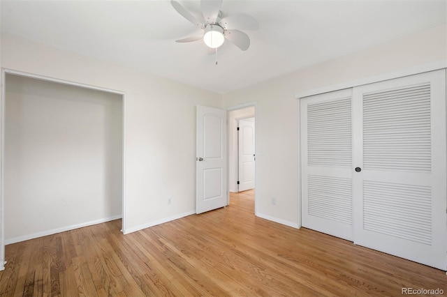 unfurnished bedroom featuring baseboards, a ceiling fan, a closet, and light wood-style flooring