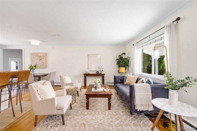 living room featuring light wood finished floors and baseboard heating