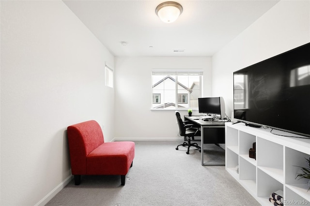 carpeted office space featuring visible vents and baseboards
