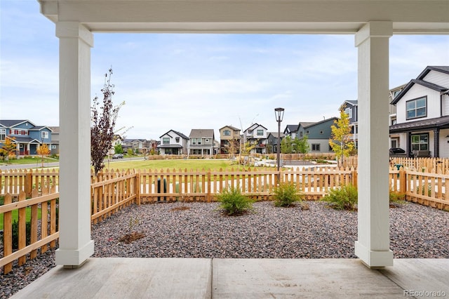 view of patio featuring fence and a residential view