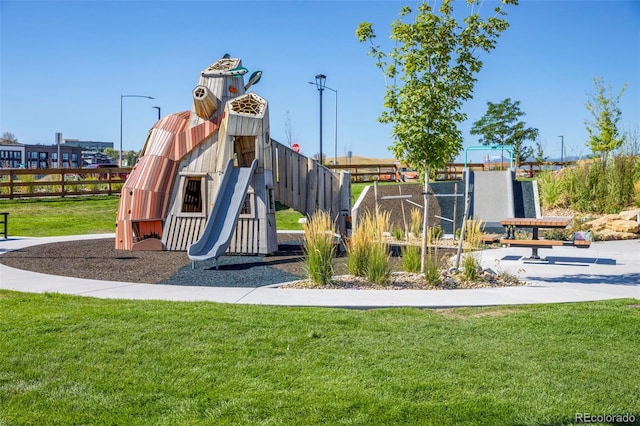 community jungle gym with fence and a yard