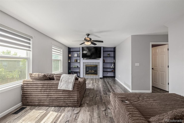 2634 E 132nd Ave, Thornton, CO 80241 - living room with wood finished floors, a ceiling fan, and a tiled fireplace