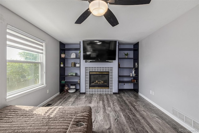 2634 E 132nd Ave, Thornton, CO 80241 - living room with wood finished floors, a tiled fireplace, and a ceiling fan