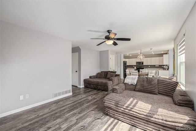 2634 E 132nd Ave, Thornton, CO 80241 - living area featuring dark wood finished floors and ceiling fan