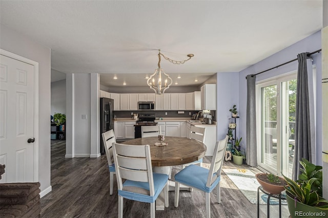 2634 E 132nd Ave, Thornton, CO 80241 - dining area featuring dark wood-type flooring, a chandelier, and recessed lighting