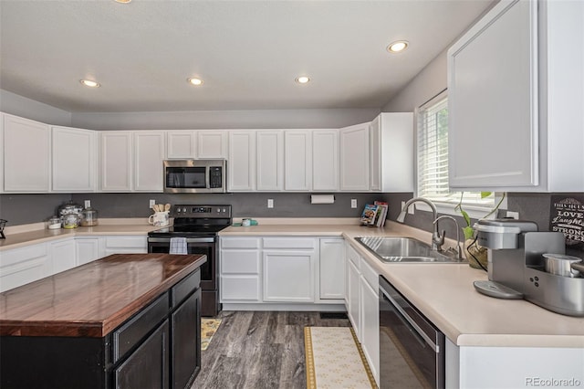 2634 E 132nd Ave, Thornton, CO 80241 - kitchen with stainless steel appliances, recessed lighting, white cabinetry, wood finished floors, and wooden counters