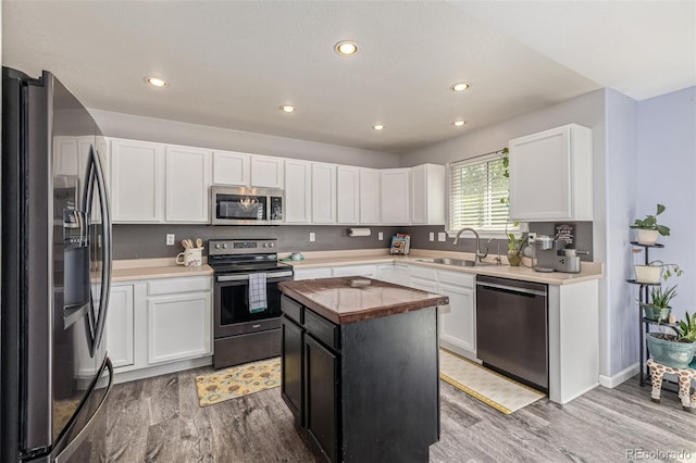2634 E 132nd Ave, Thornton, CO 80241 - kitchen featuring stainless steel appliances, wood finished floors, butcher block countertops, white cabinets, and recessed lighting