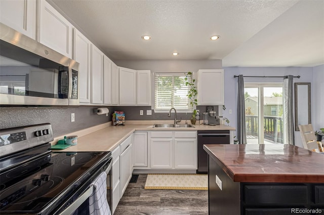 2634 E 132nd Ave, Thornton, CO 80241 - kitchen featuring stainless steel appliances, dark wood finished floors, recessed lighting, white cabinets, and wooden counters