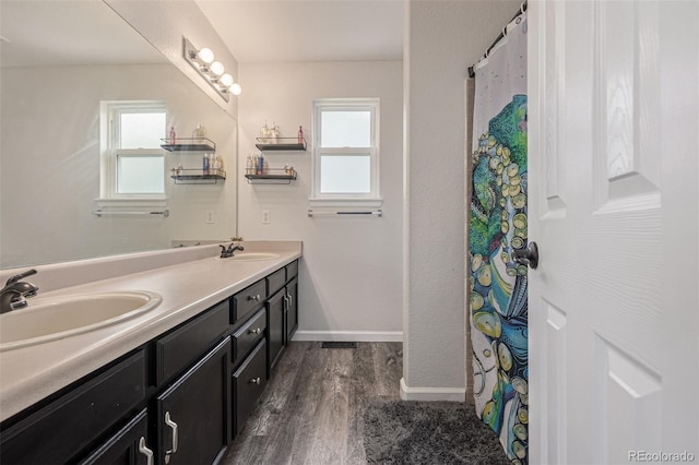 2634 E 132nd Ave, Thornton, CO 80241 - full bathroom featuring wood finished floors, double vanity, and healthy amount of natural light
