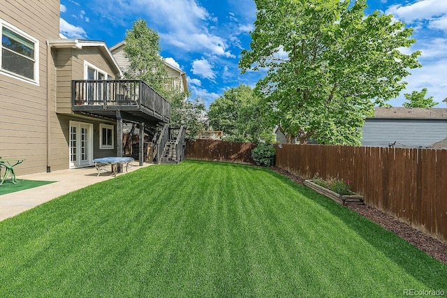 2634 E 132nd Ave, Thornton, CO 80241 - fenced backyard with stairway, a wooden deck, and a patio area