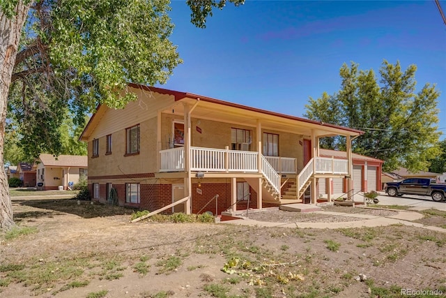 1291 W 3rd Ave, Broomfield, CO 80020 - view of front of property featuring a garage, stairs, and a porch