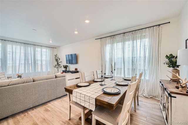 dining space with light wood-style flooring and recessed lighting