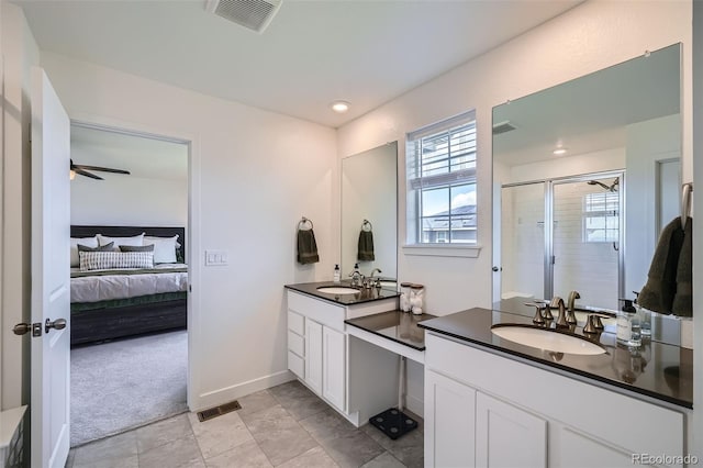ensuite bathroom with connected bathroom, vanity, visible vents, and a stall shower