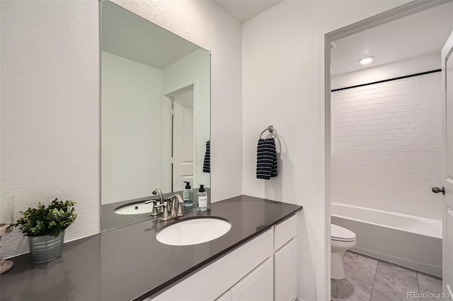 full bath with toilet, marble finish floor, vanity, and  shower combination